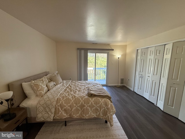 bedroom with dark hardwood / wood-style floors, access to outside, and a closet