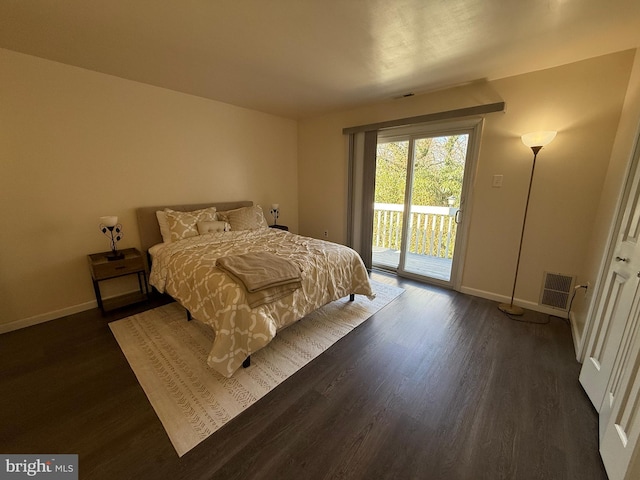 bedroom featuring dark hardwood / wood-style flooring and access to outside