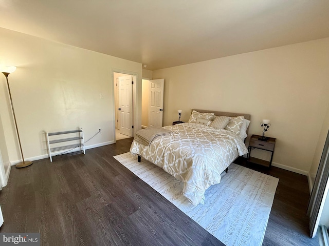 bedroom with dark wood-type flooring and heating unit