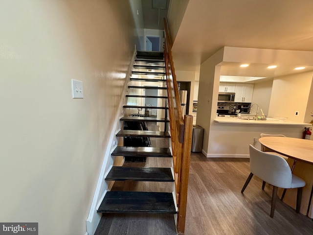 stairs featuring wood-type flooring