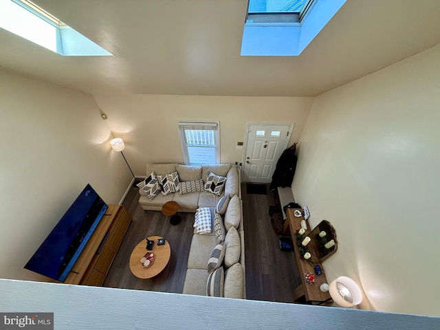 living room with hardwood / wood-style floors and a skylight