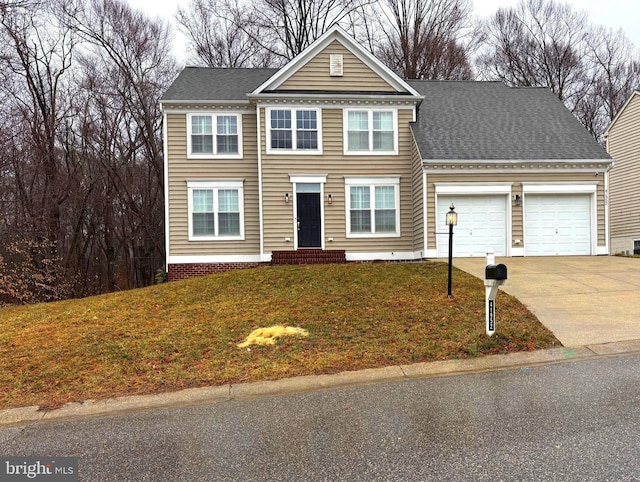 view of front property with a garage and a front yard