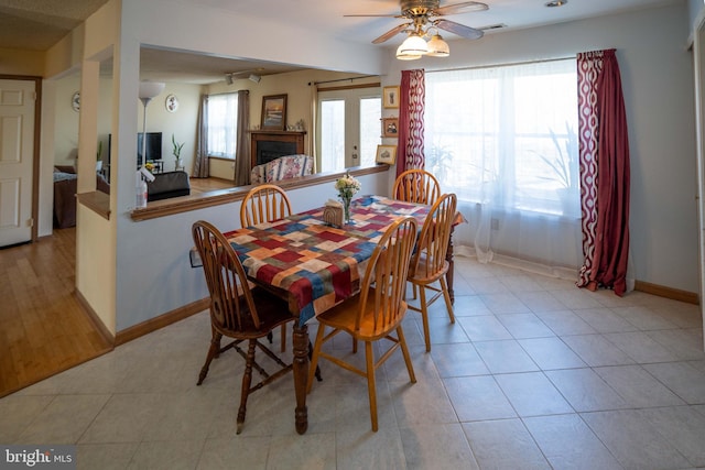 tiled dining room featuring ceiling fan