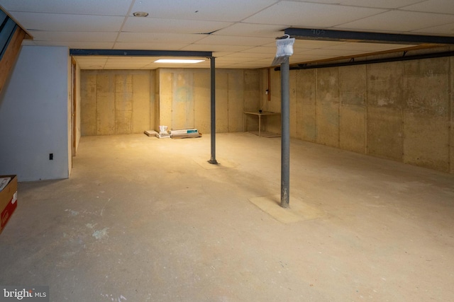 basement with a paneled ceiling