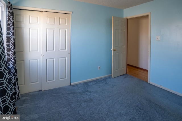 unfurnished bedroom featuring a closet and carpet flooring