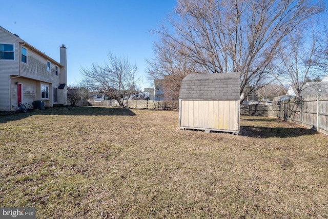 view of yard with central air condition unit and a storage unit