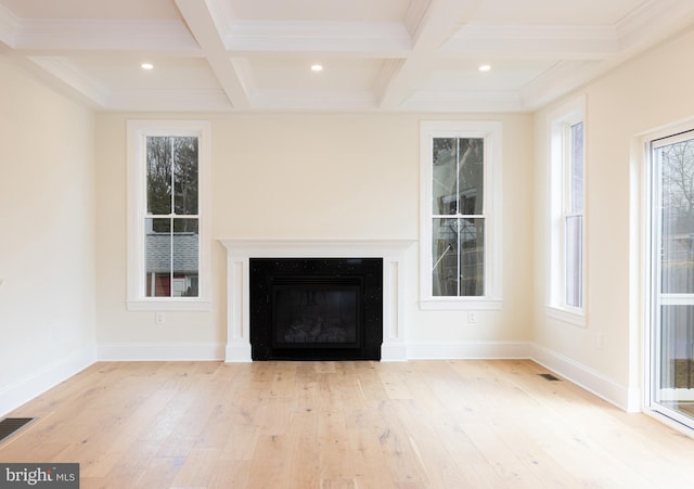 unfurnished living room with beam ceiling, crown molding, coffered ceiling, and light hardwood / wood-style floors