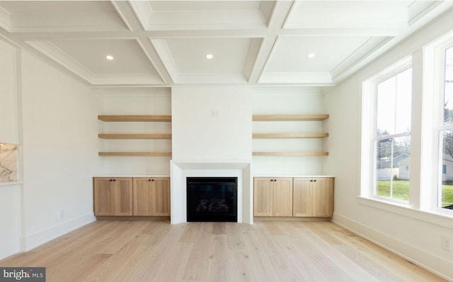 unfurnished living room with beamed ceiling, coffered ceiling, and light hardwood / wood-style floors