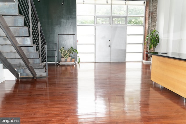 interior space featuring hardwood / wood-style flooring and a towering ceiling