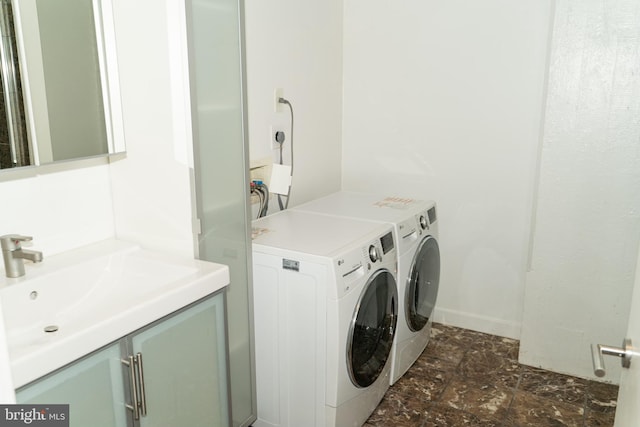 clothes washing area with sink and washer and clothes dryer