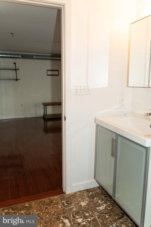 bathroom with hardwood / wood-style flooring and vanity