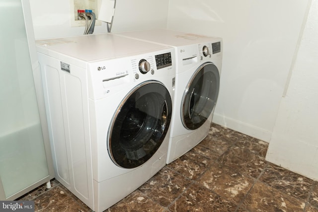 clothes washing area featuring independent washer and dryer