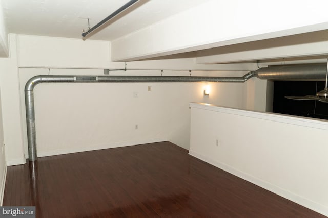 basement with dark hardwood / wood-style flooring