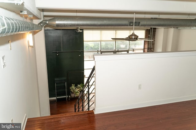 unfurnished dining area featuring dark wood-type flooring