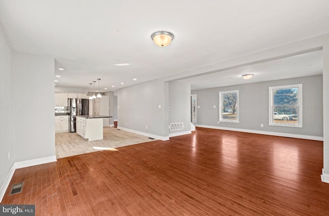 unfurnished living room featuring light wood-type flooring