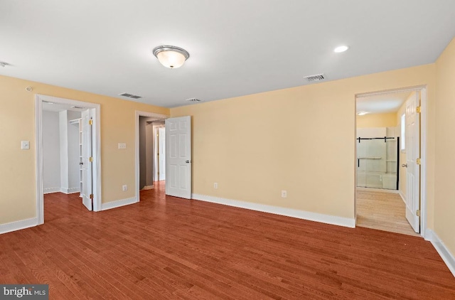 unfurnished bedroom with hardwood / wood-style flooring