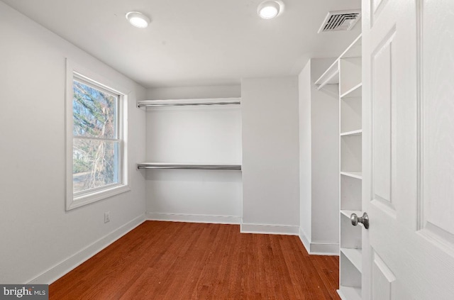 walk in closet with hardwood / wood-style floors