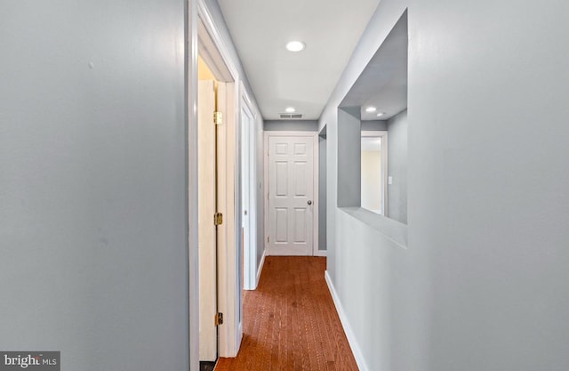 corridor with hardwood / wood-style floors