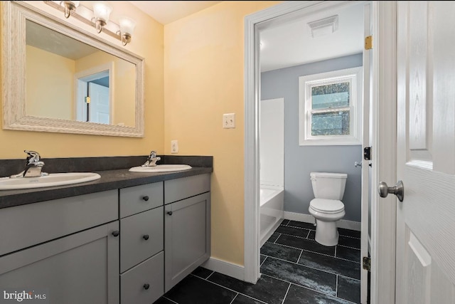 bathroom with tile patterned flooring, vanity, and toilet