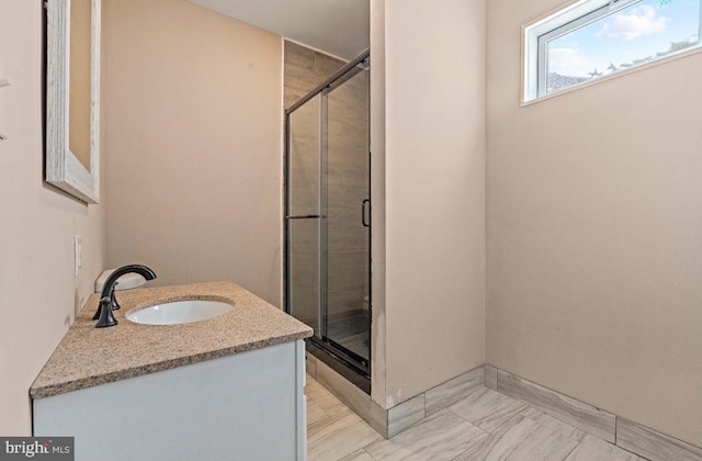 bathroom with an enclosed shower and vanity