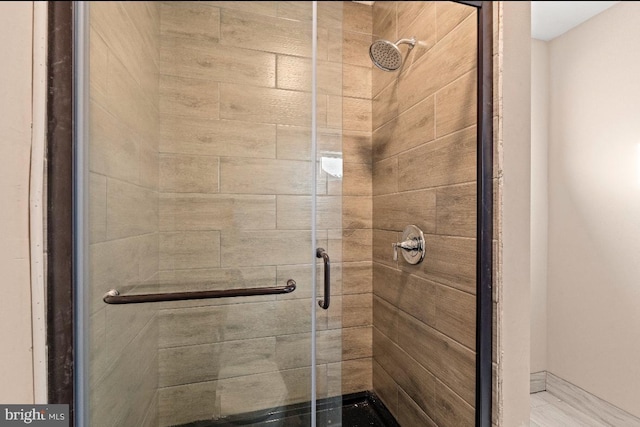 bathroom featuring a shower with door