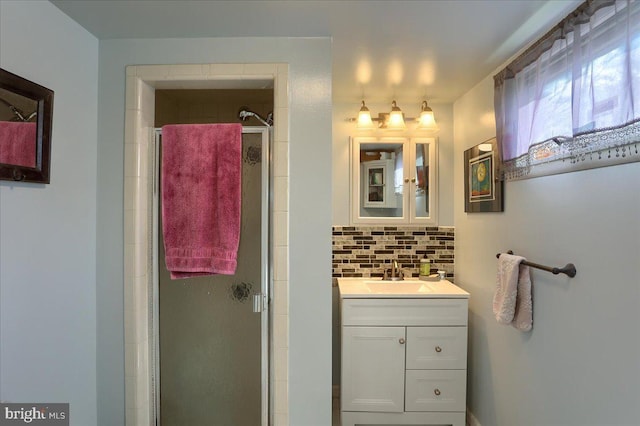 bathroom with vanity, backsplash, and walk in shower