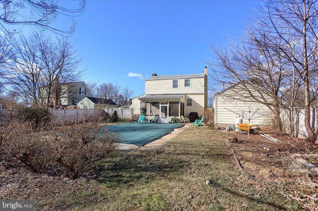 rear view of house with a patio area and a sunroom