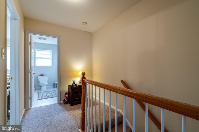 hallway with light colored carpet