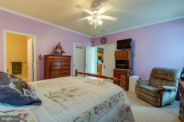 carpeted bedroom with ornamental molding and ceiling fan