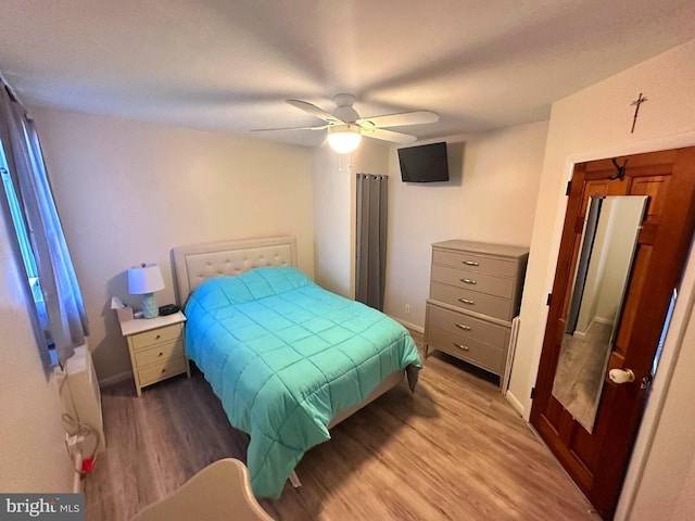 bedroom featuring hardwood / wood-style flooring and ceiling fan