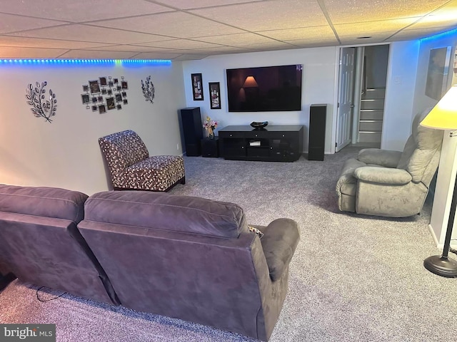 living room featuring carpet and a paneled ceiling