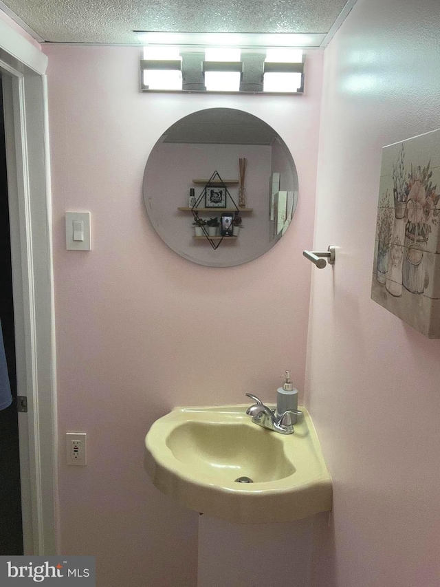 bathroom featuring sink and a textured ceiling