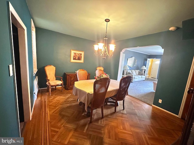 dining room with parquet floors and a notable chandelier