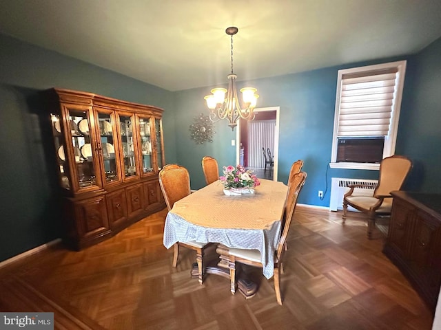 dining room featuring an inviting chandelier, dark parquet flooring, and radiator heating unit