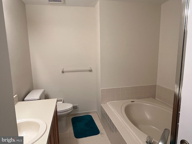 bathroom with tile patterned flooring, vanity, a relaxing tiled tub, and toilet