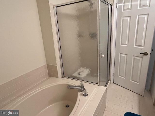 bathroom with tile patterned flooring and separate shower and tub