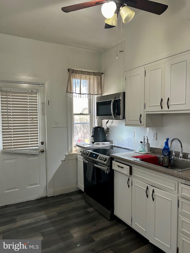 kitchen featuring sink, ceiling fan, white cabinetry, range with electric cooktop, and dark hardwood / wood-style flooring