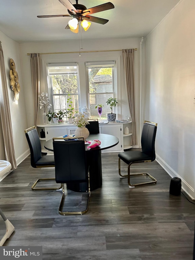 dining space with dark hardwood / wood-style floors and ceiling fan