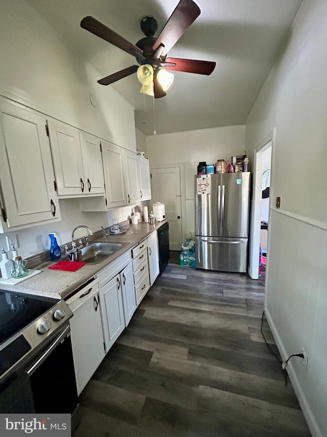 kitchen with sink, white cabinets, dark hardwood / wood-style flooring, ceiling fan, and stainless steel appliances