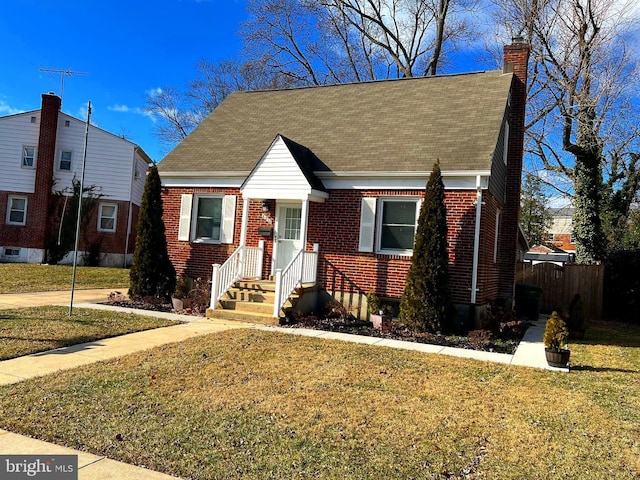 view of front facade featuring a front yard and brick siding