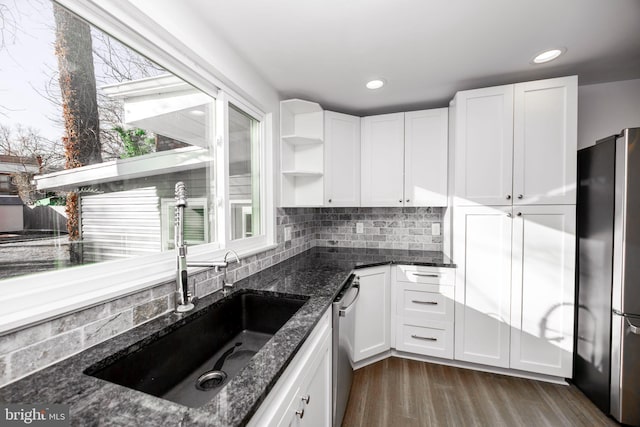 kitchen with open shelves, stainless steel appliances, a sink, and white cabinets