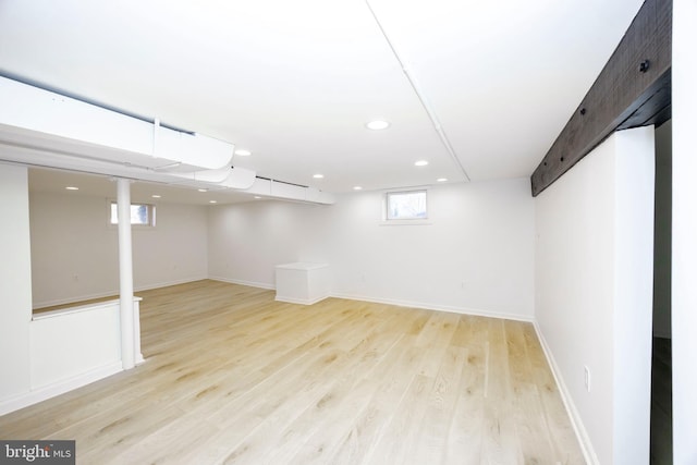 basement featuring light wood finished floors, recessed lighting, and baseboards