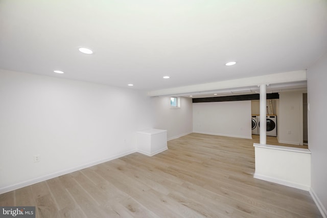 basement with recessed lighting, baseboards, washer and clothes dryer, and light wood finished floors