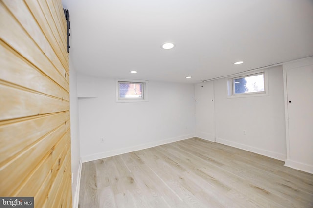 basement with light wood finished floors, recessed lighting, and baseboards