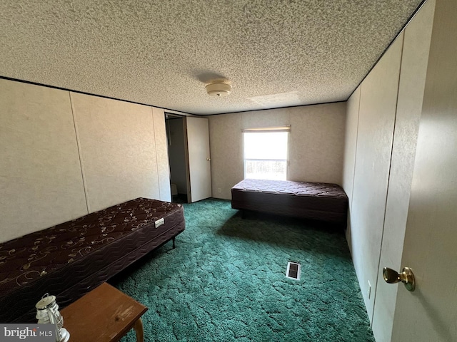 unfurnished bedroom with carpet and a textured ceiling