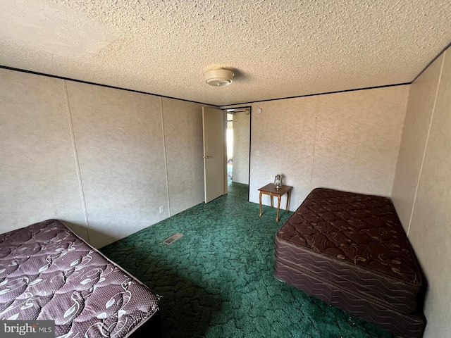 unfurnished bedroom featuring a textured ceiling and carpet