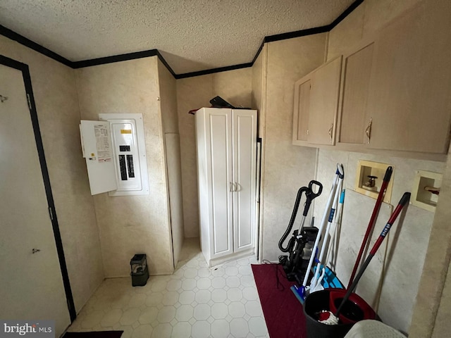 interior space featuring ornamental molding, electric panel, and a textured ceiling