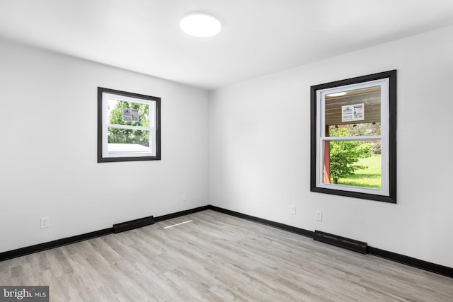 spare room featuring light wood-type flooring