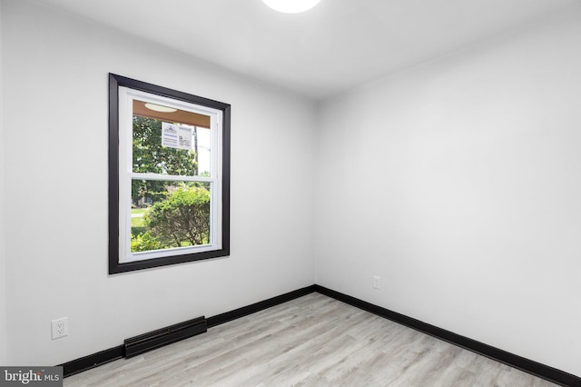 spare room featuring light hardwood / wood-style floors