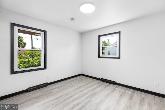 empty room with light hardwood / wood-style floors